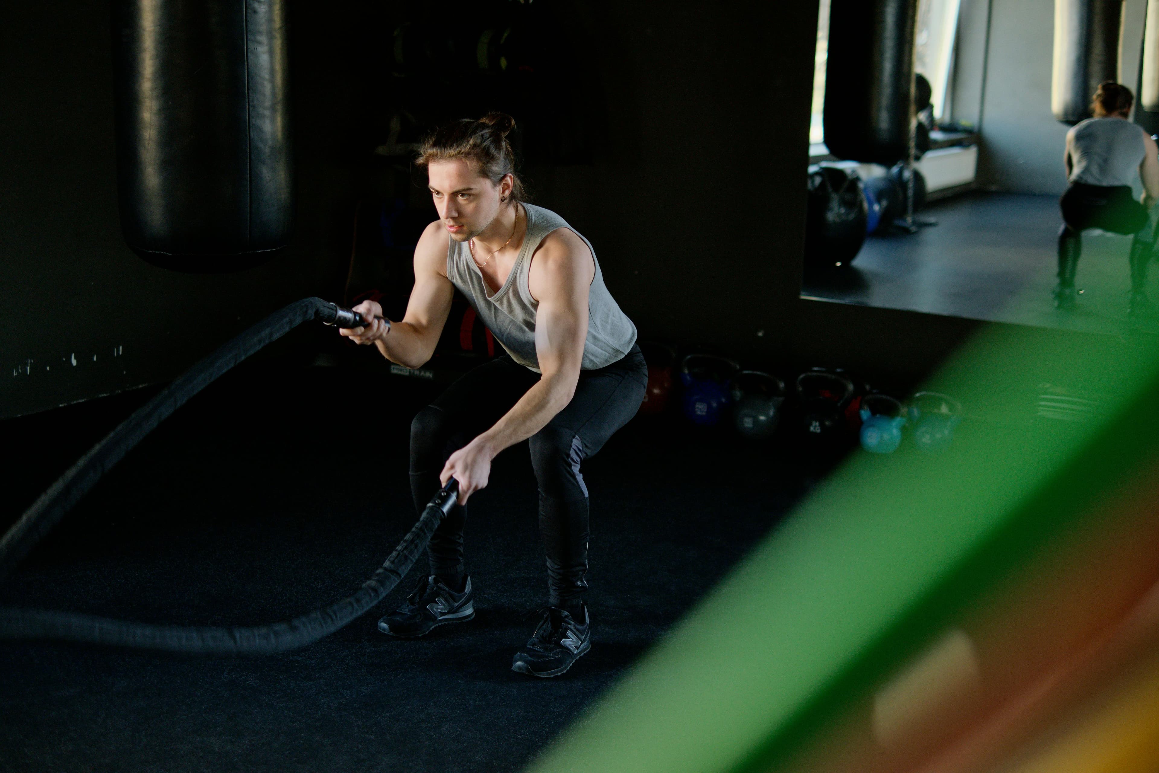 Athlete performing battle rope exercises